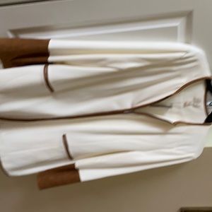 A beautiful cream dressy jacket with brown around the sleeves